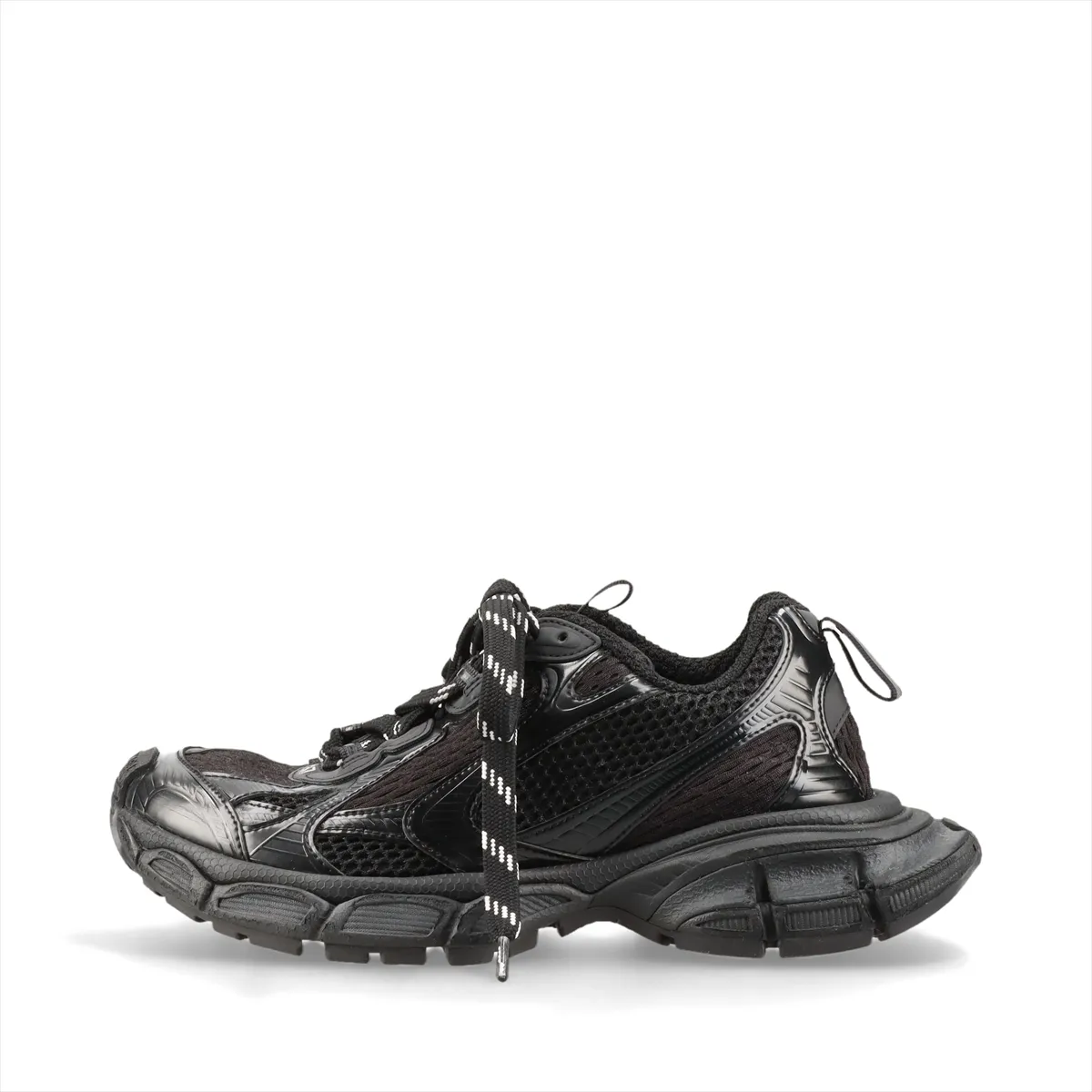 Oversized black chunky sneaker with mesh panels and a thick heavily textured sole.