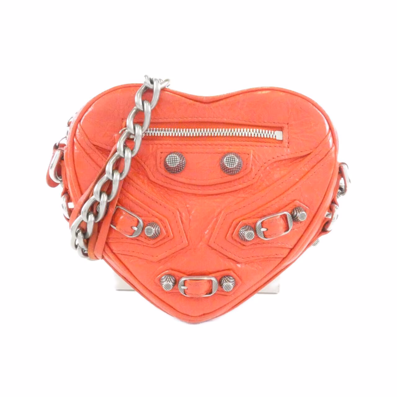 Small heart-shaped bag with studded hardware and a slim shoulder strap.