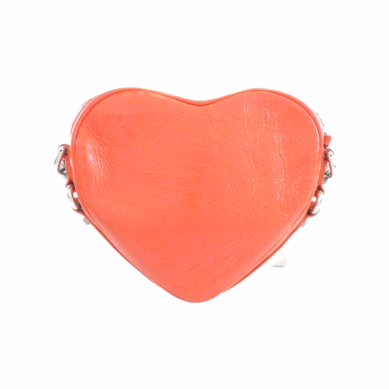 Small heart-shaped bag with studded hardware and a slim shoulder strap.