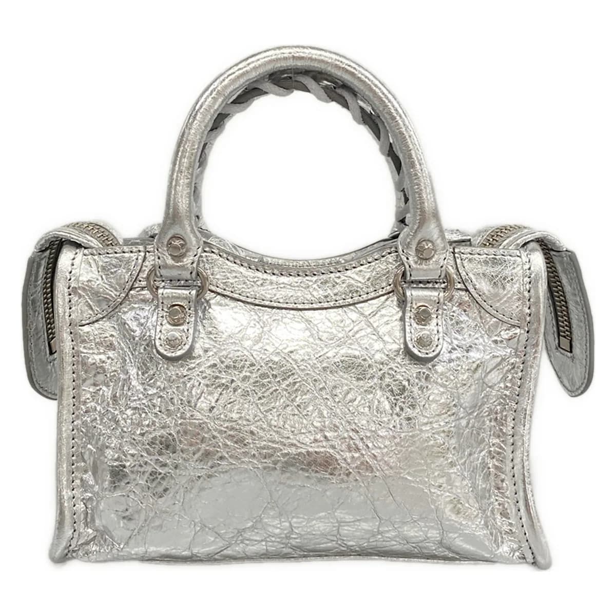 Very small metallic silver handbag with twin rolled handles and zip closure.
