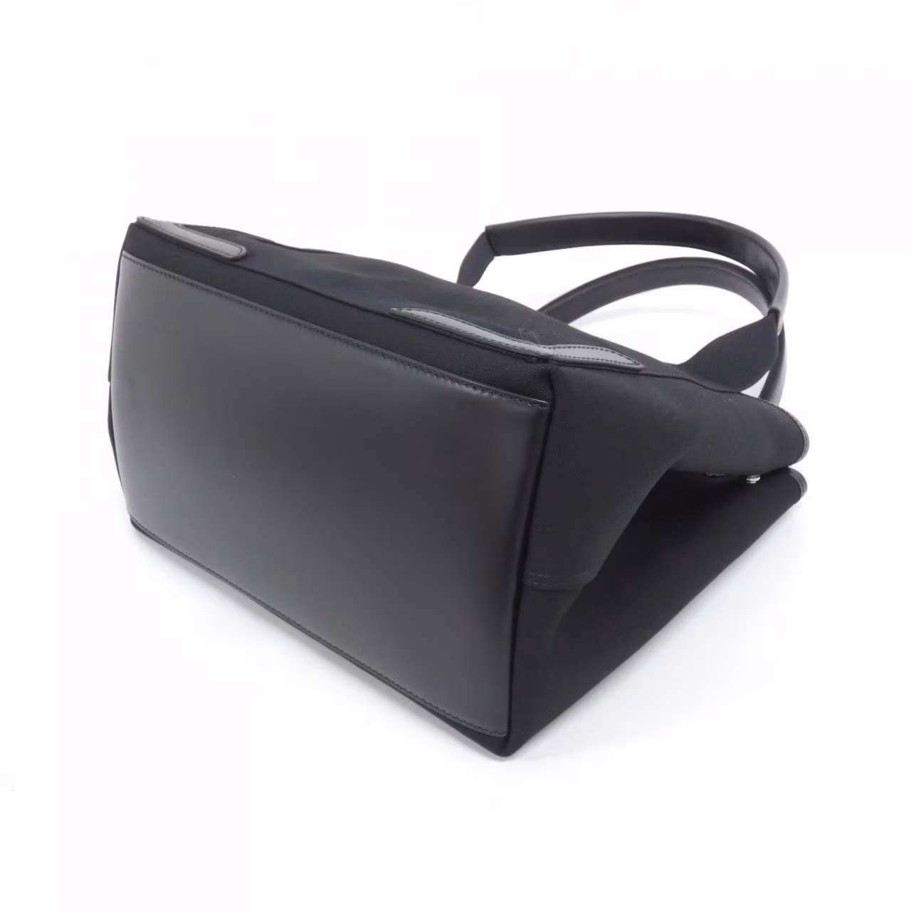 Small structured tote with rolled handles and open top, shown upright on a white background