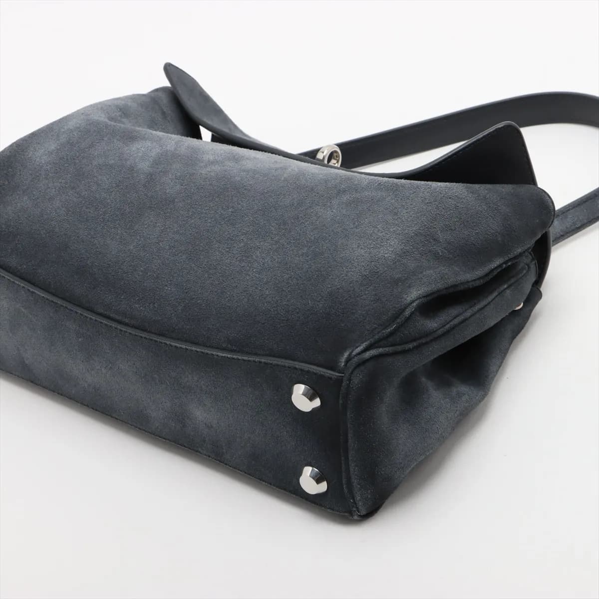 Slouchy grey suede handbag with a curved top handle, hanging key holder and detachable strap.