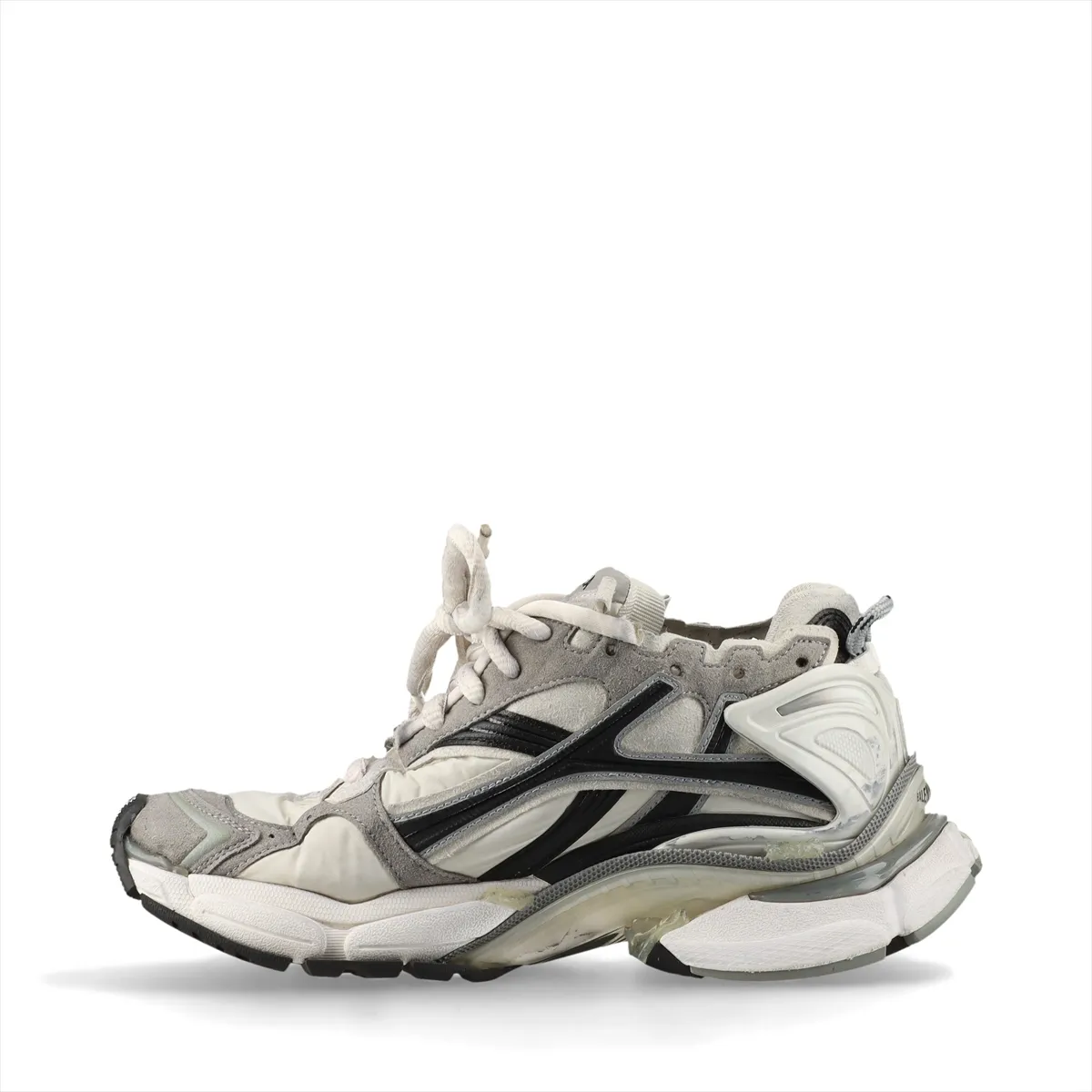 Grey low-top running-style sneakers with layered suede and fabric panels and an intentionally scuffed, aged finish.