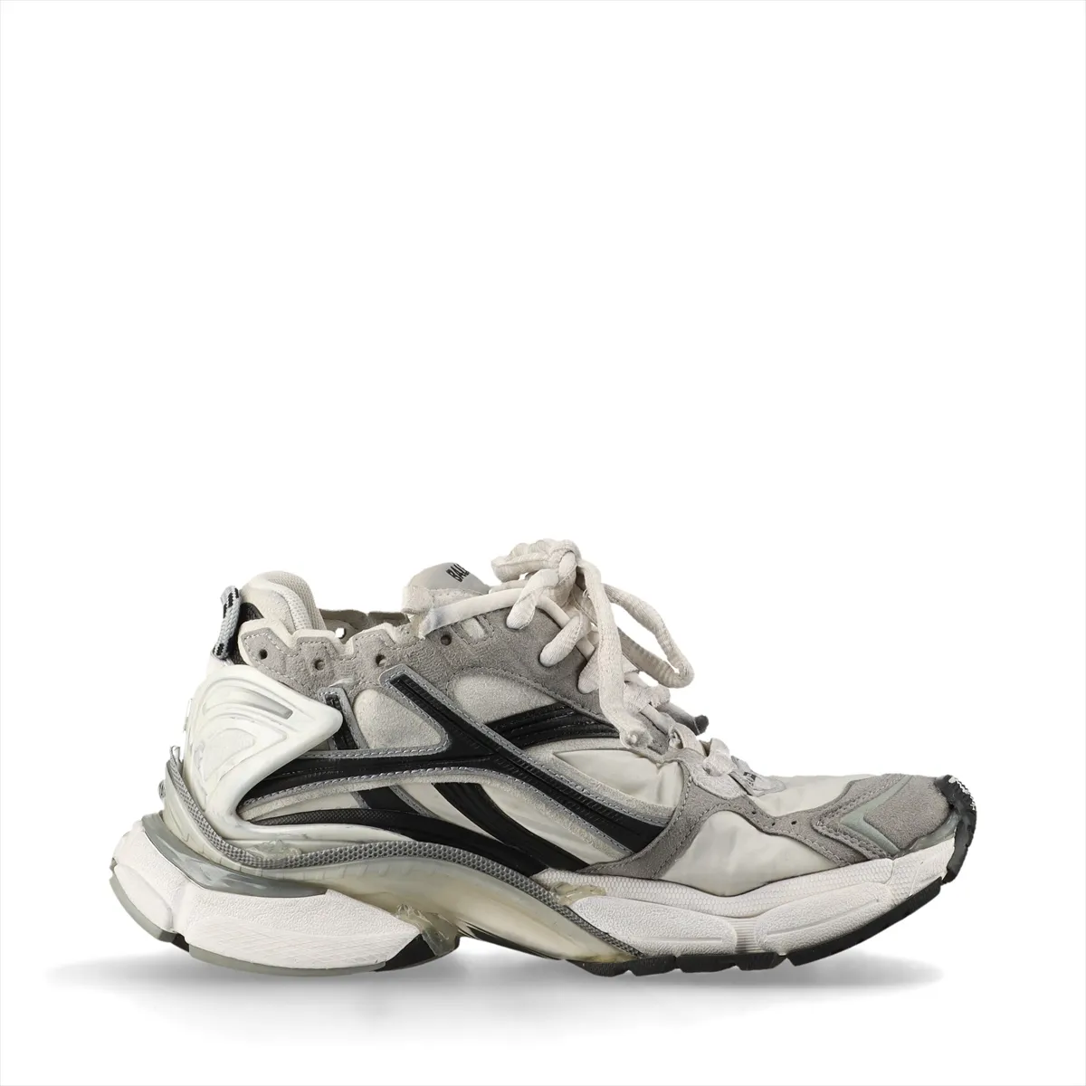 Grey low-top running-style sneakers with layered suede and fabric panels and an intentionally scuffed, aged finish.