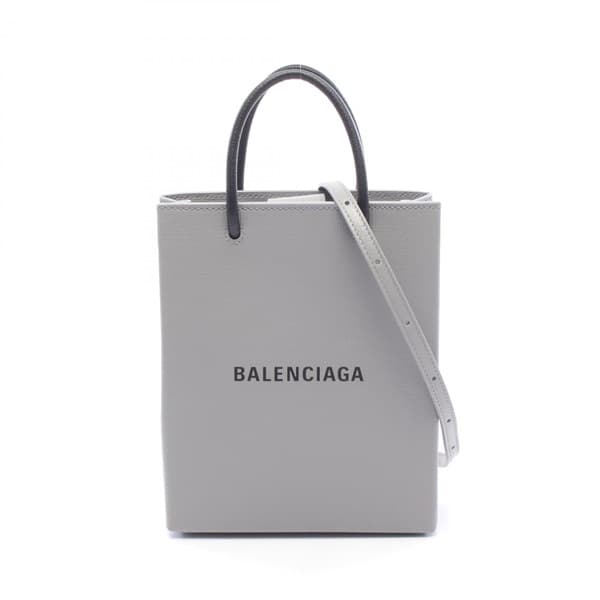 Small structured tote in grey and black leather with twin handles and a detachable strap.