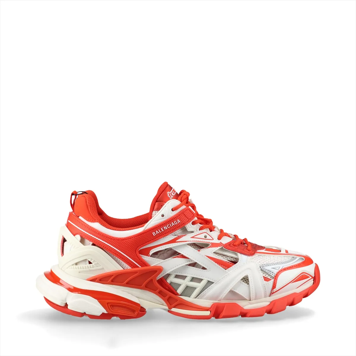Chunky layered low-top sneakers in white with orange panels and mesh sections, shown in profile.