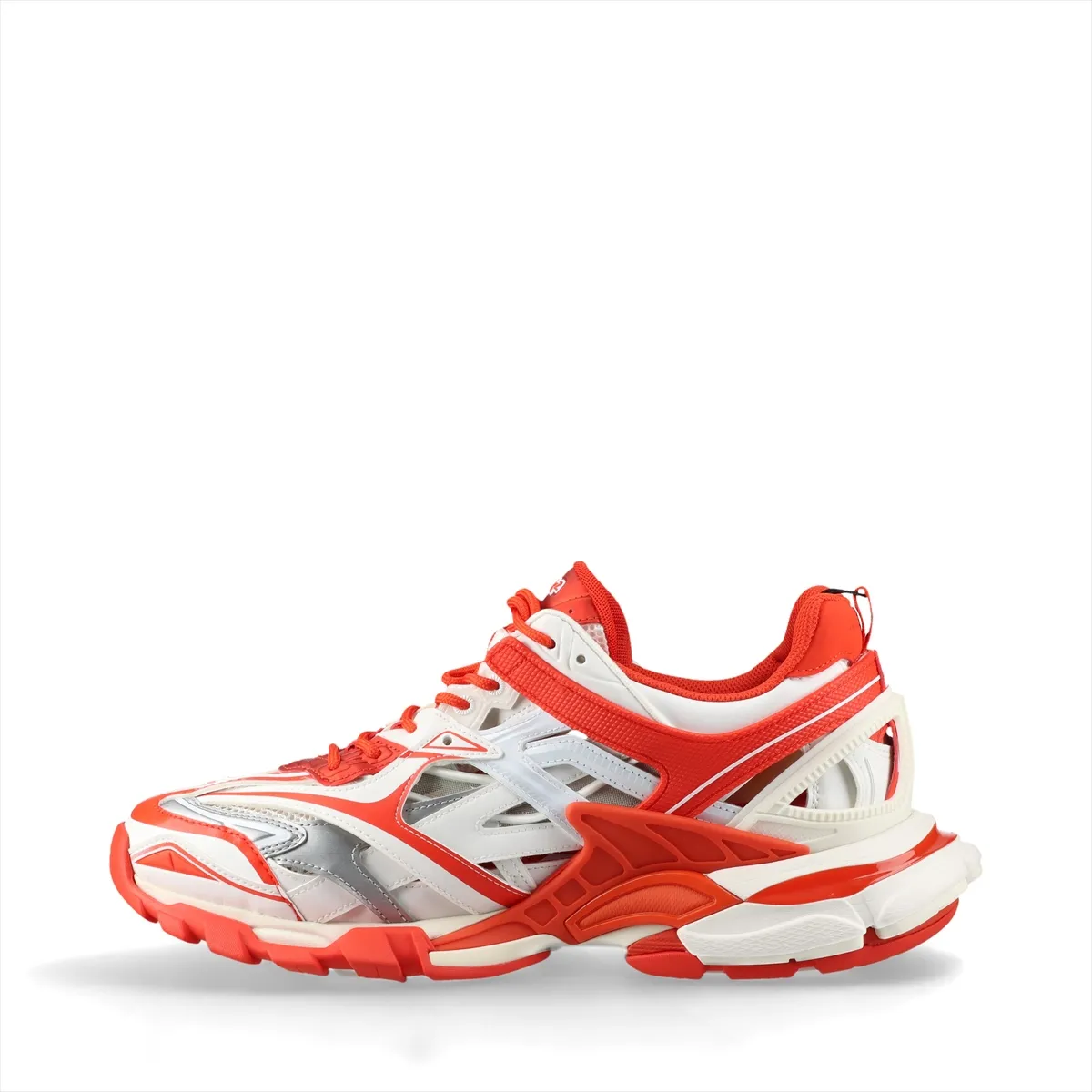 Chunky layered low-top sneakers in white with orange panels and mesh sections, shown in profile.
