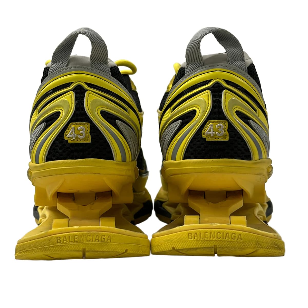 Chunky exaggerated-sole trainers in a dark tone, shown from the side.
