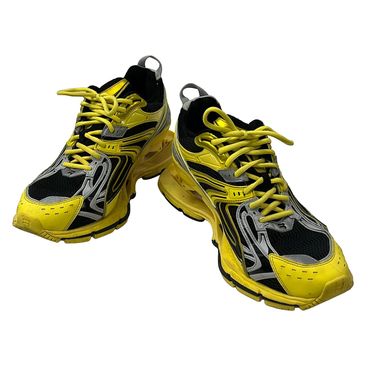Chunky exaggerated-sole trainers in a dark tone, shown from the side.