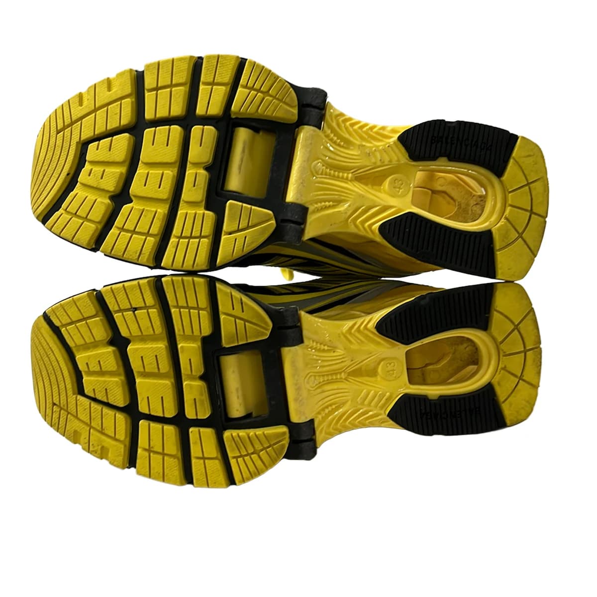 Chunky exaggerated-sole trainers in a dark tone, shown from the side.