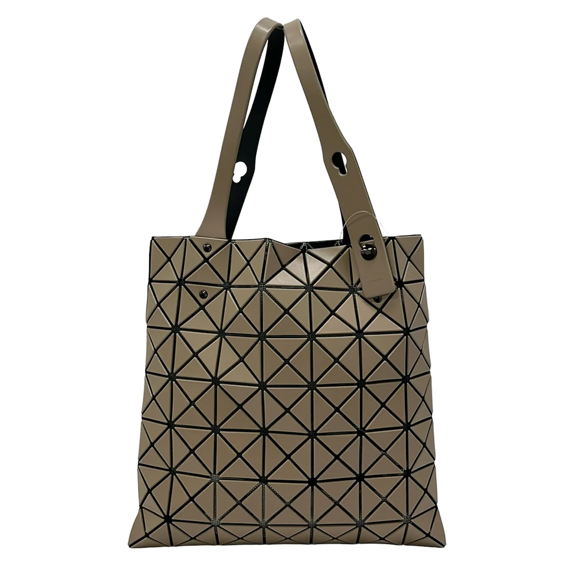 Tote bag built from geometric triangular panels in beige and black.