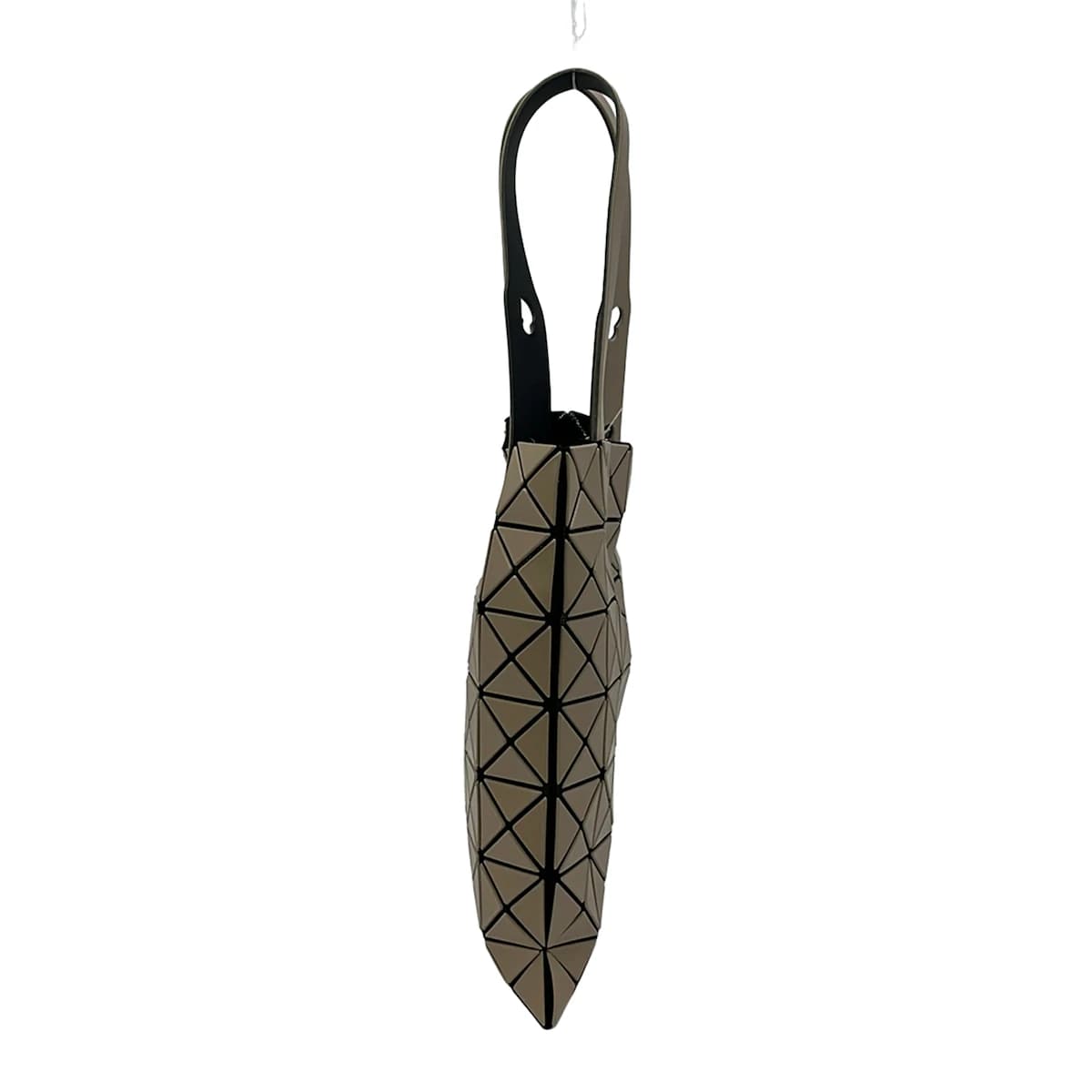 Tote bag built from geometric triangular panels in beige and black.
