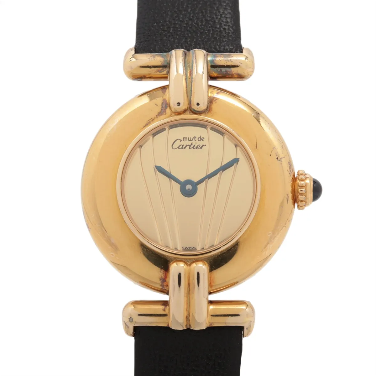 Small oval-cased wristwatch with champagne dial and dark leather strap.