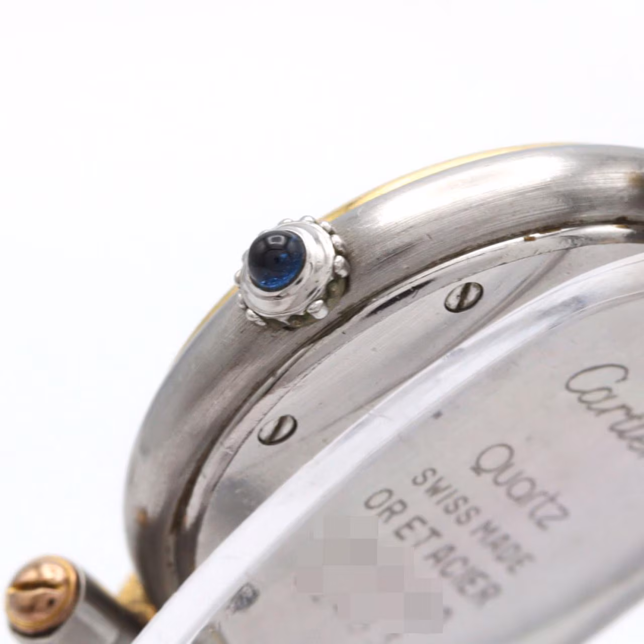 Small two-tone watch with square dial, Roman numerals and steel-and-gold link bracelet.