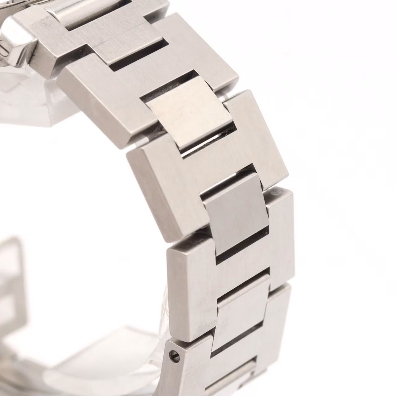 Round steel wristwatch with a white dial, date window and screw-down crown cover on a steel bracelet.