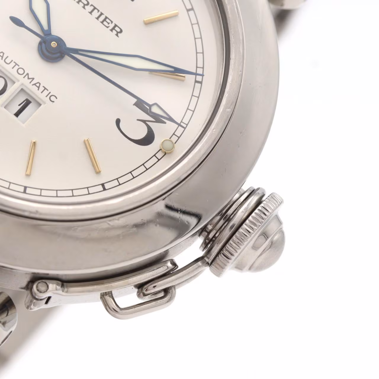 Round steel watch with large date aperture, chained crown cover and steel bracelet.