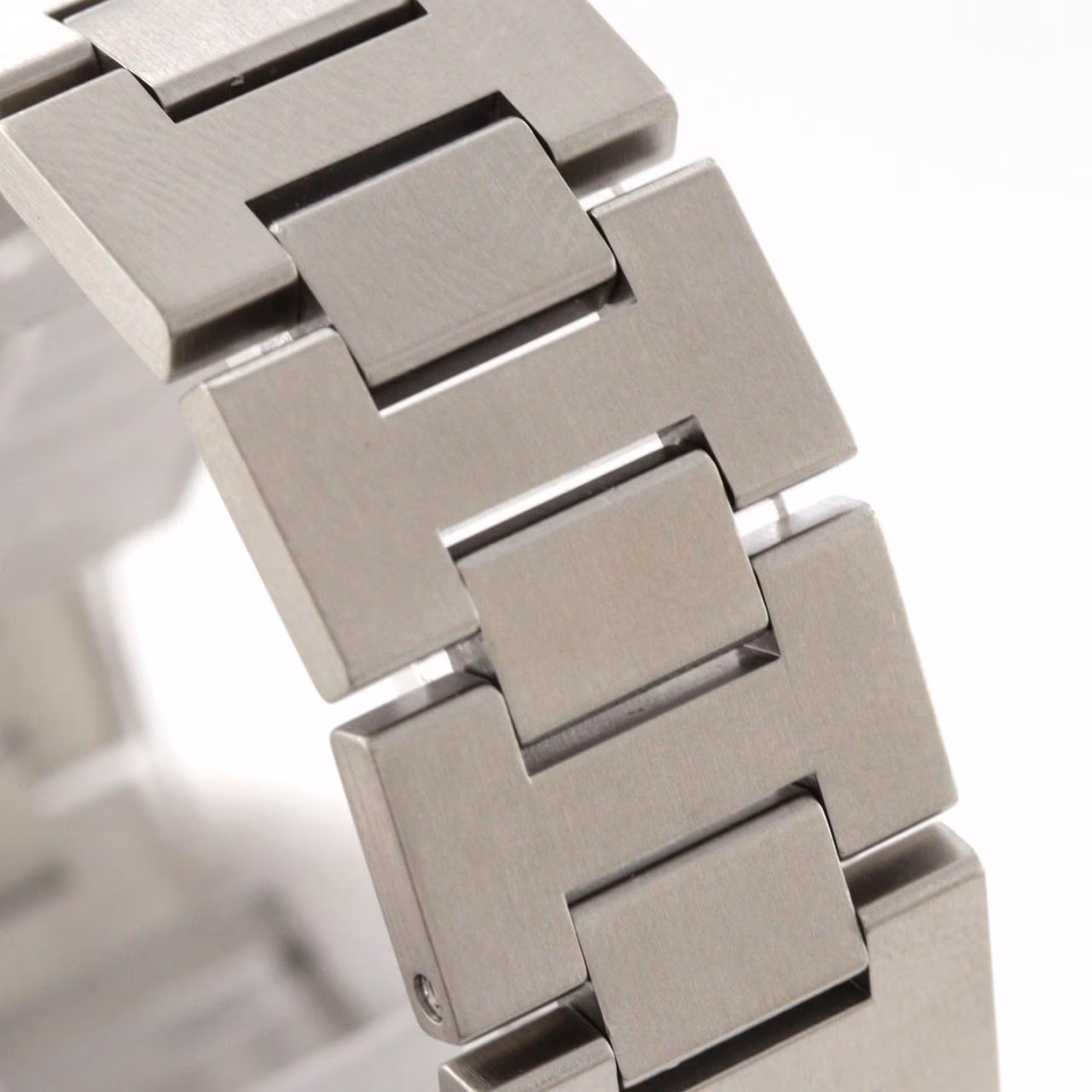 Round steel wristwatch with a screw-down crown cap and large date display.