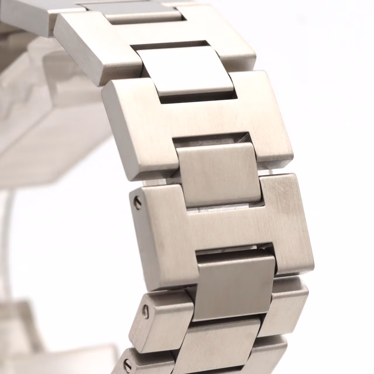Round steel watch with a screw-down crown cap on a steel bracelet.