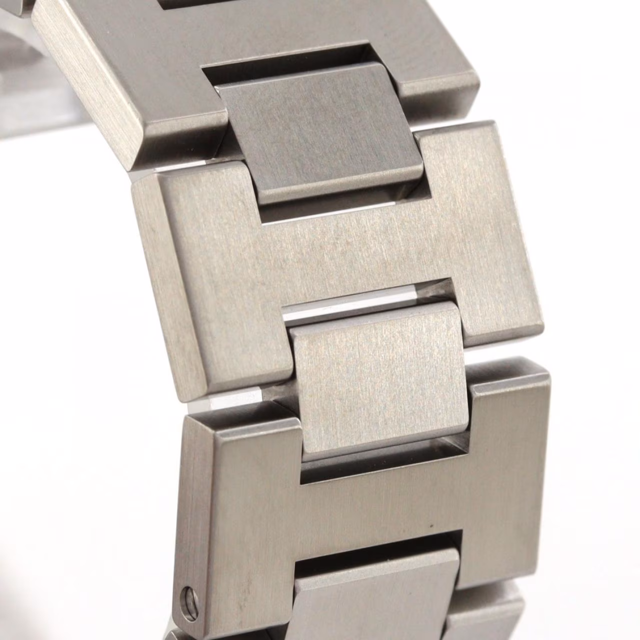 Round steel watch with a screw-down crown cover and steel bracelet.