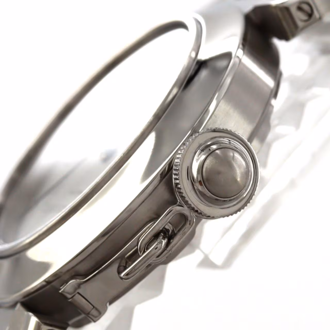 Round steel watch with a screw-down crown cover and steel bracelet.