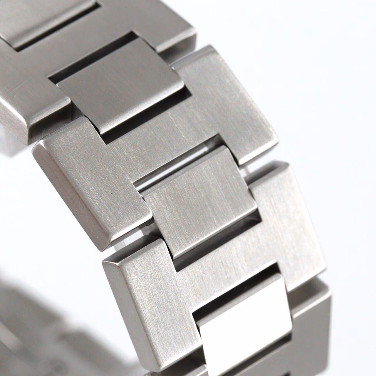 Round steel wristwatch with Arabic numerals, a screw-down crown cap and steel bracelet.