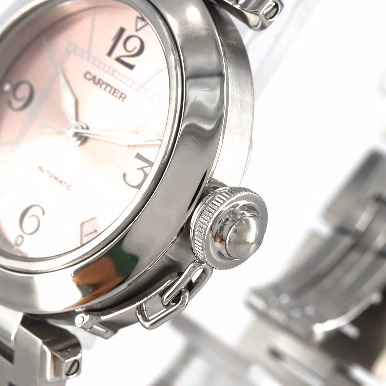 Round steel wristwatch with Arabic numerals, a screw-down crown cap and steel bracelet.