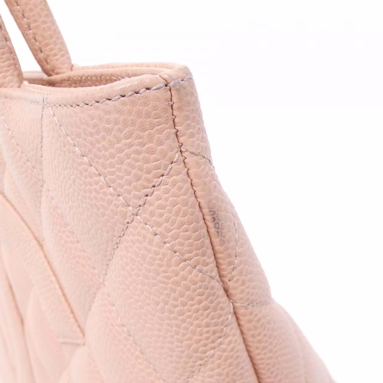 Quilted handbag with a chain strap, photographed against a plain background.