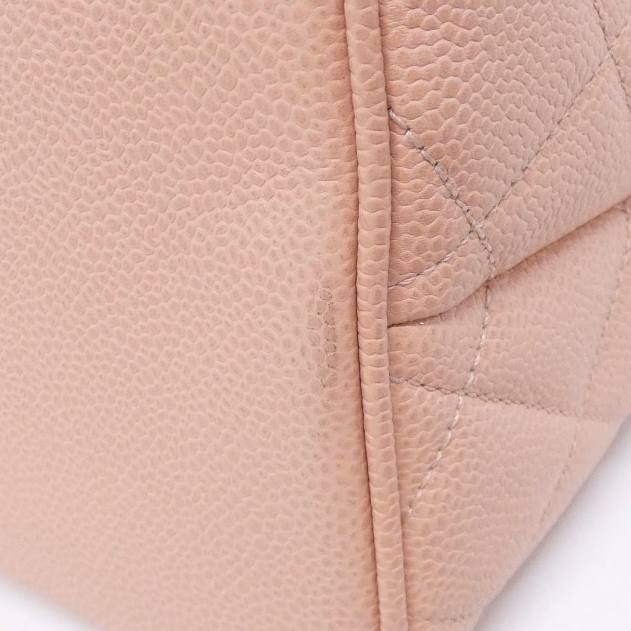 Quilted handbag with a chain strap, photographed against a plain background.
