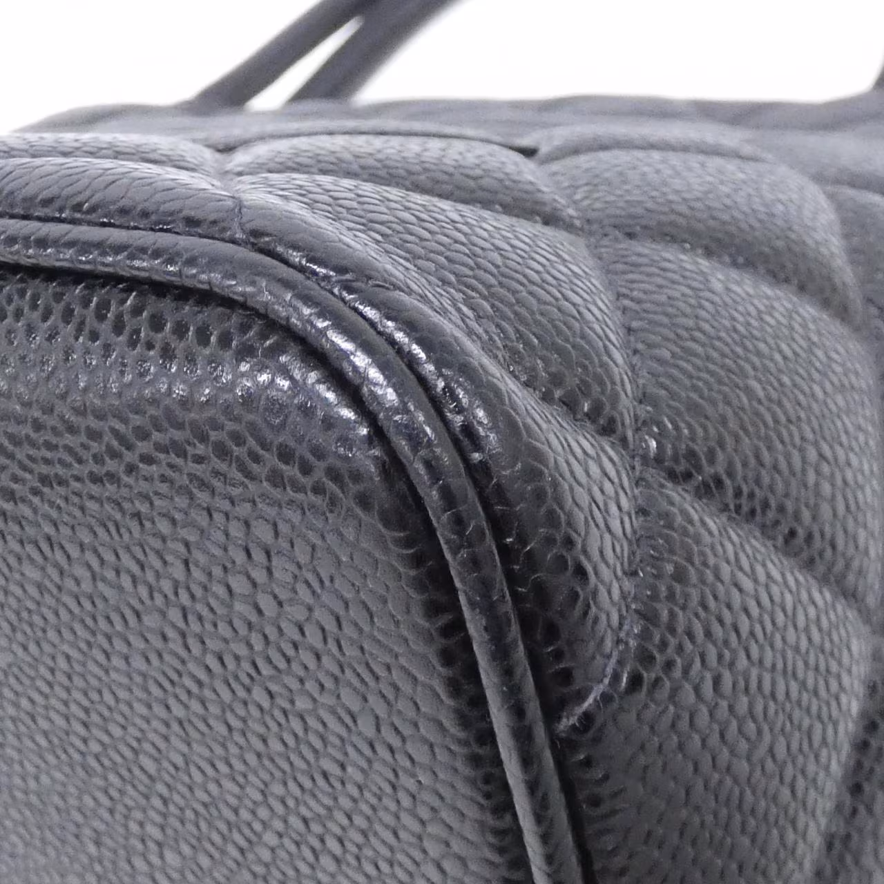 Black quilted bag with gold-tone chain strap and interlocking logo clasp.