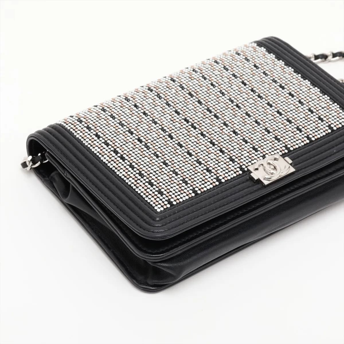 Black quilted leather flap wallet with a wide silver-tone clasp and chain strap.