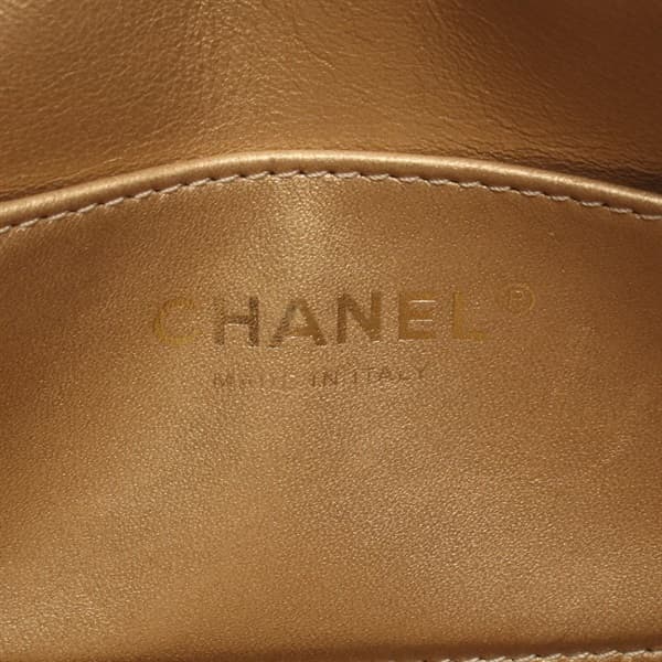 Black quilted leather camera bag with gold-tone logo clasp and a shoulder strap.