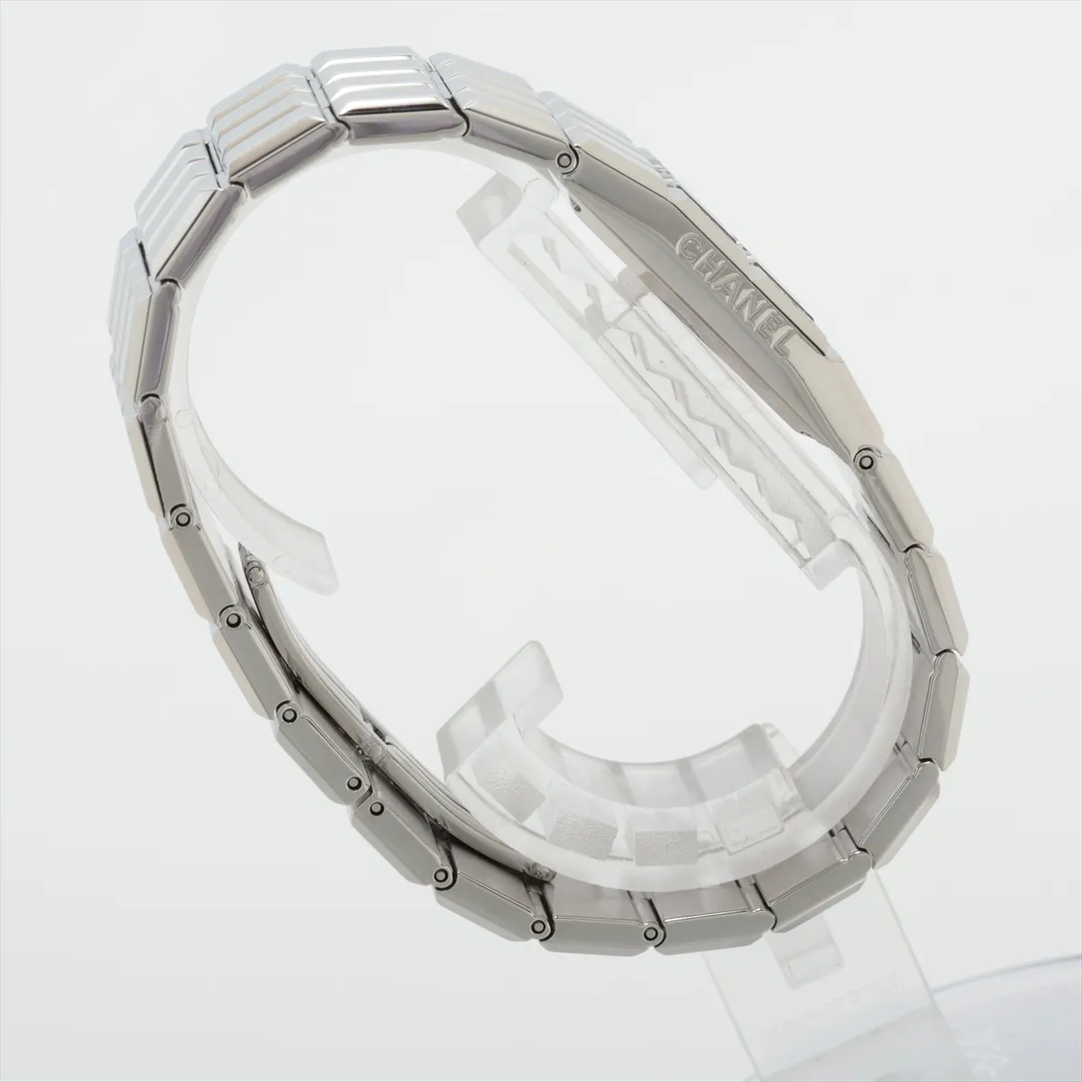 Slim rectangular stainless steel watch with digital display and integrated steel bracelet.