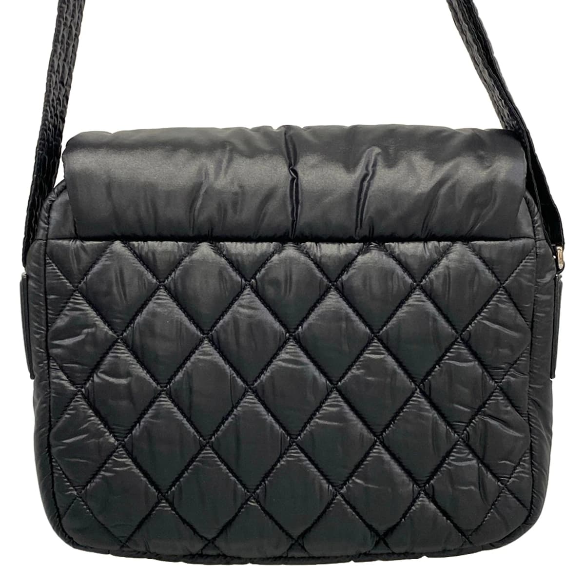 Softly padded black shoulder bag with horizontal quilting and rounded handles.