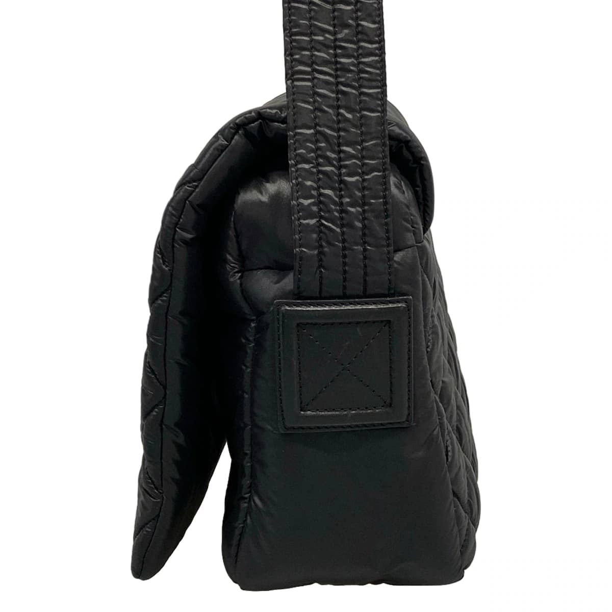 Softly padded black shoulder bag with horizontal quilting and rounded handles.