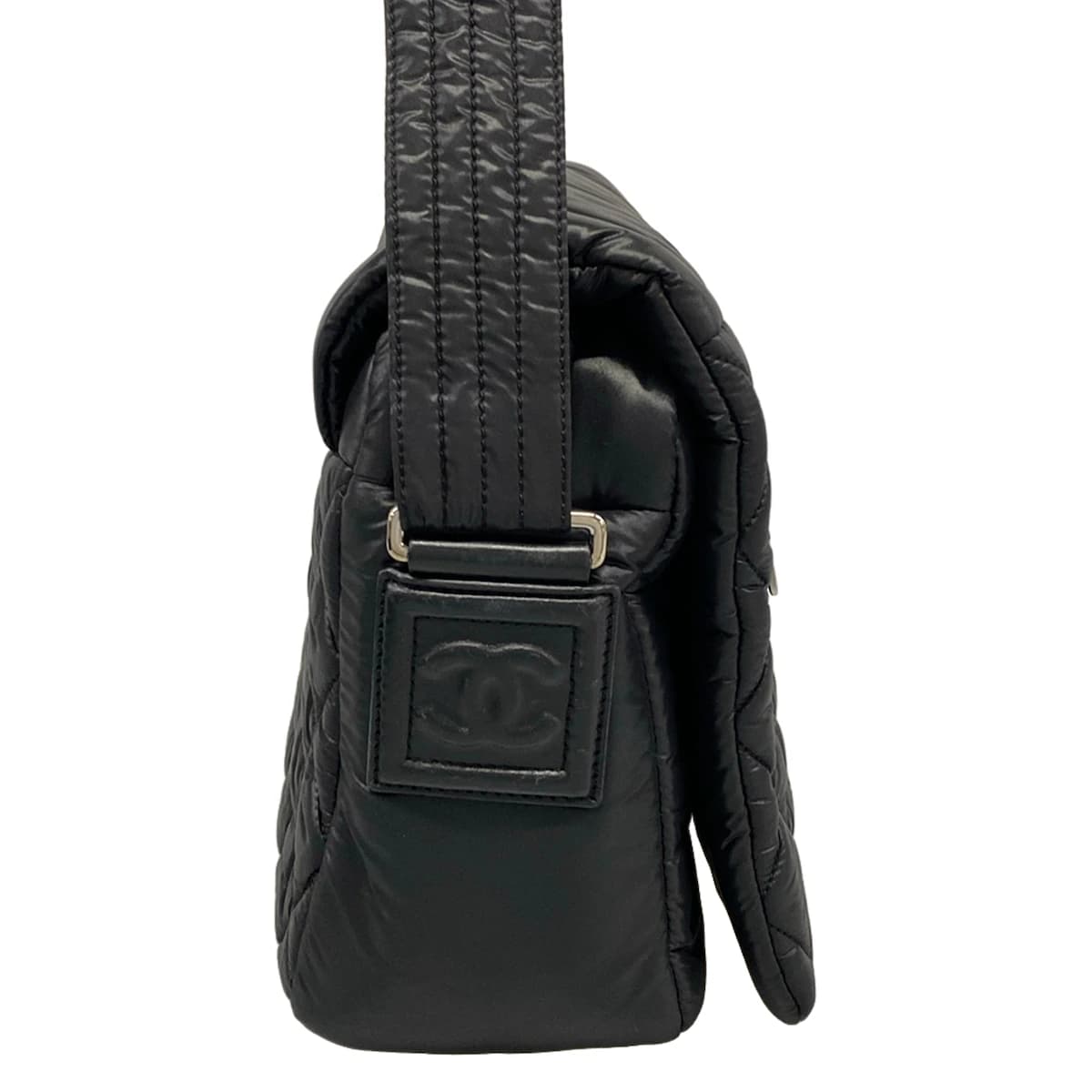 Softly padded black shoulder bag with horizontal quilting and rounded handles.