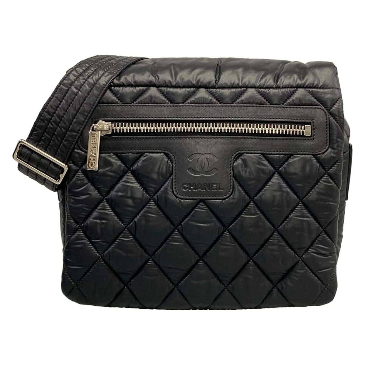 Softly padded black shoulder bag with horizontal quilting and rounded handles.