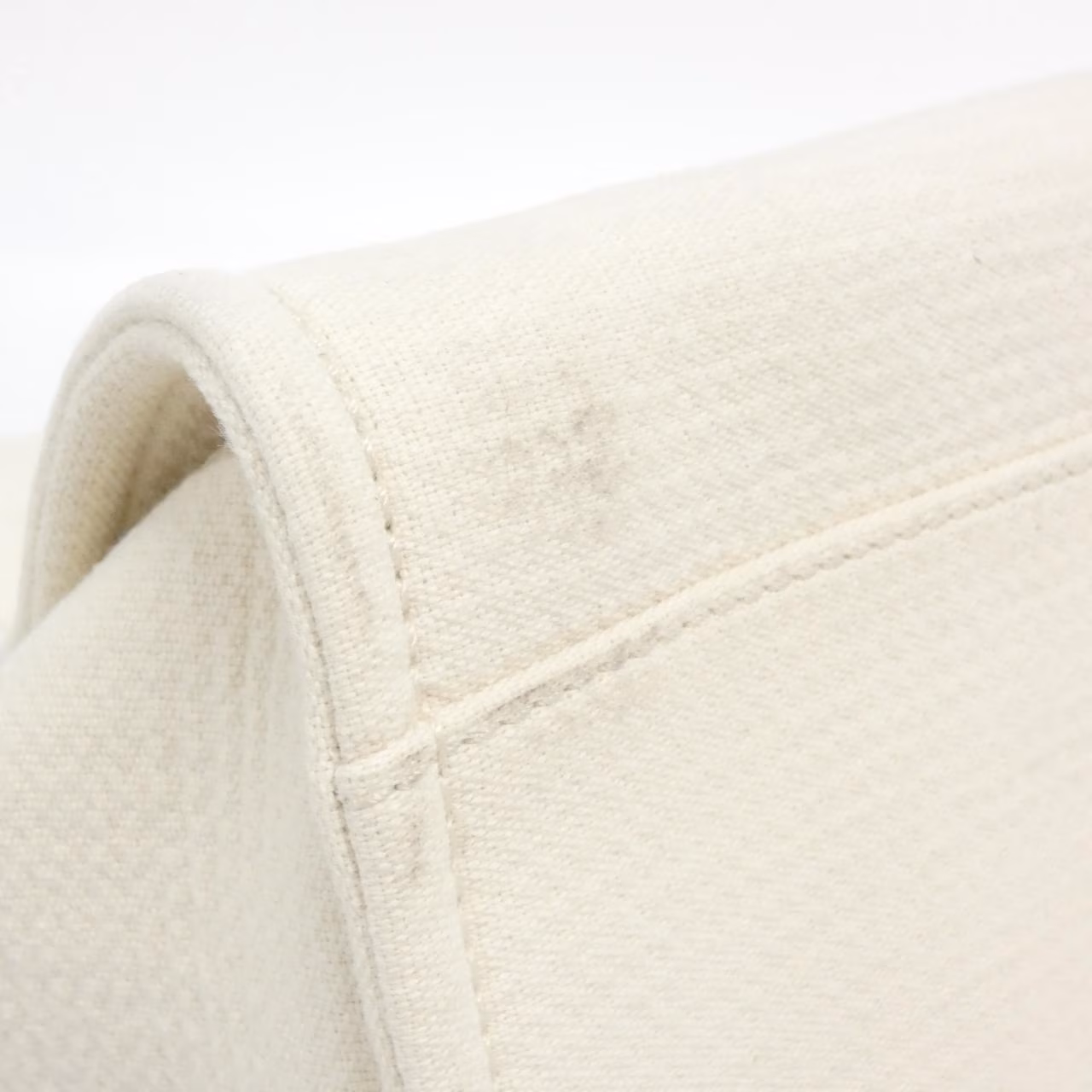 Tote bag with woven handles and a large logo on the front.