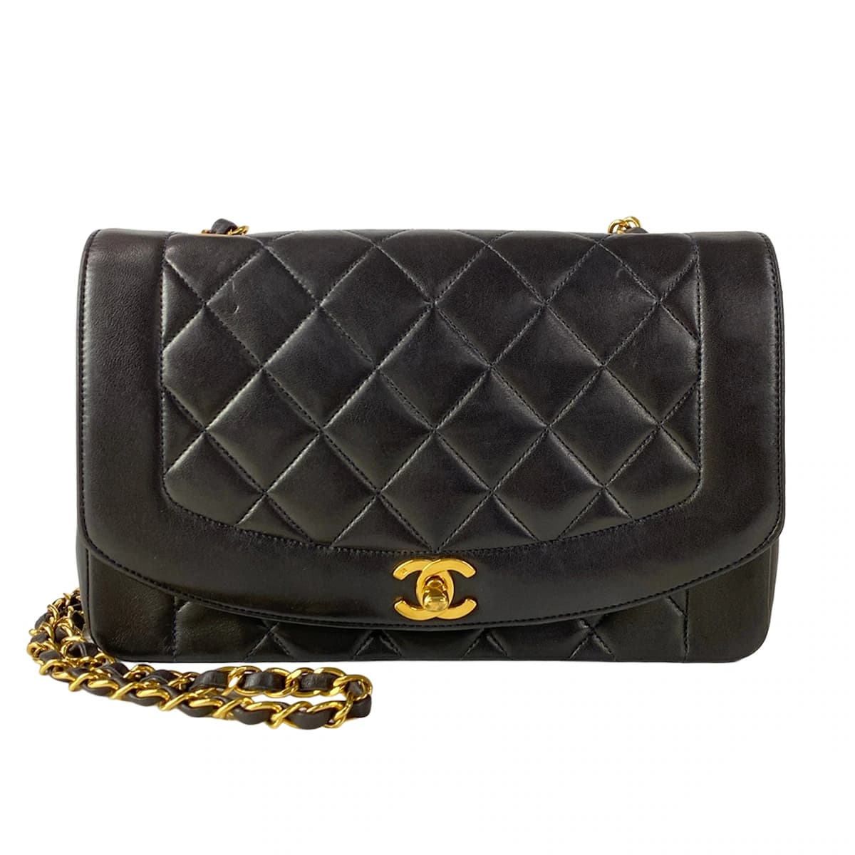 Quilted black flap bag with a turnlock closure and a thin chain-and-leather shoulder strap.