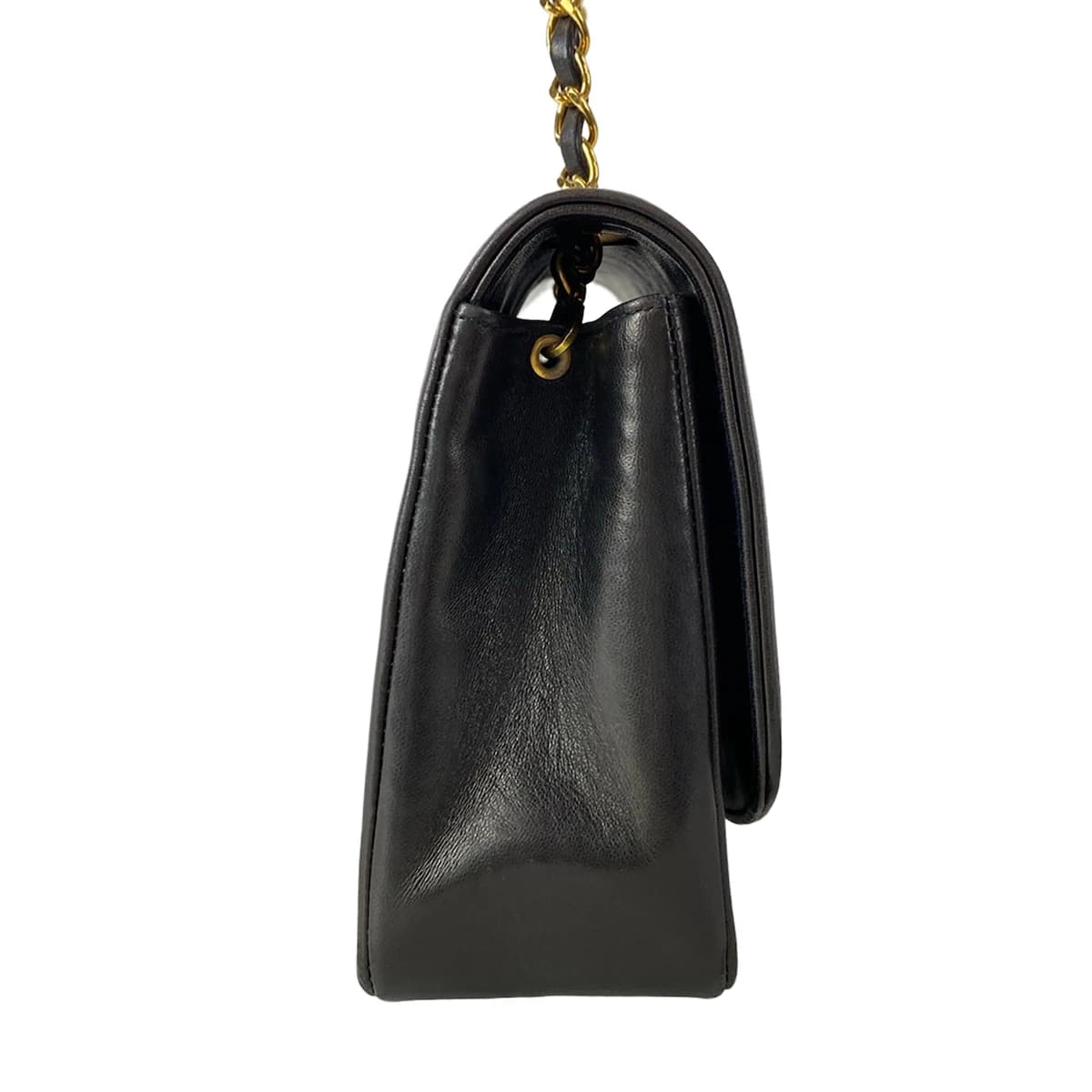 Quilted black flap bag with a turnlock closure and a thin chain-and-leather shoulder strap.