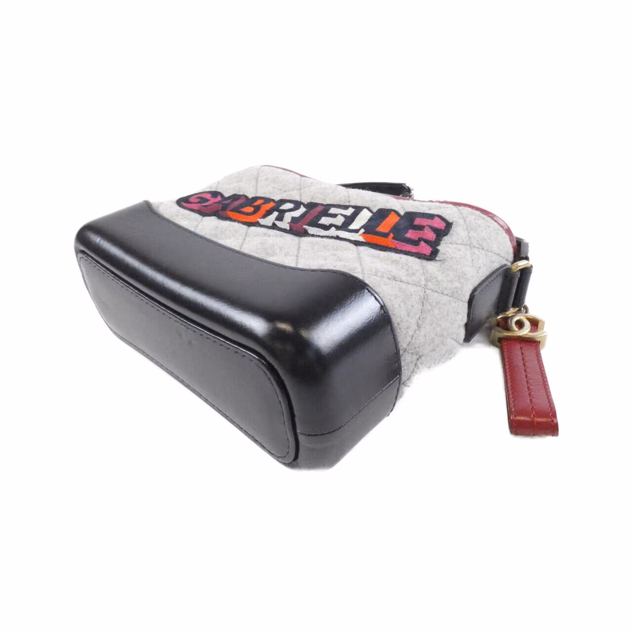 Quilted shoulder bag with a rounded body and mixed-metal chain strap.