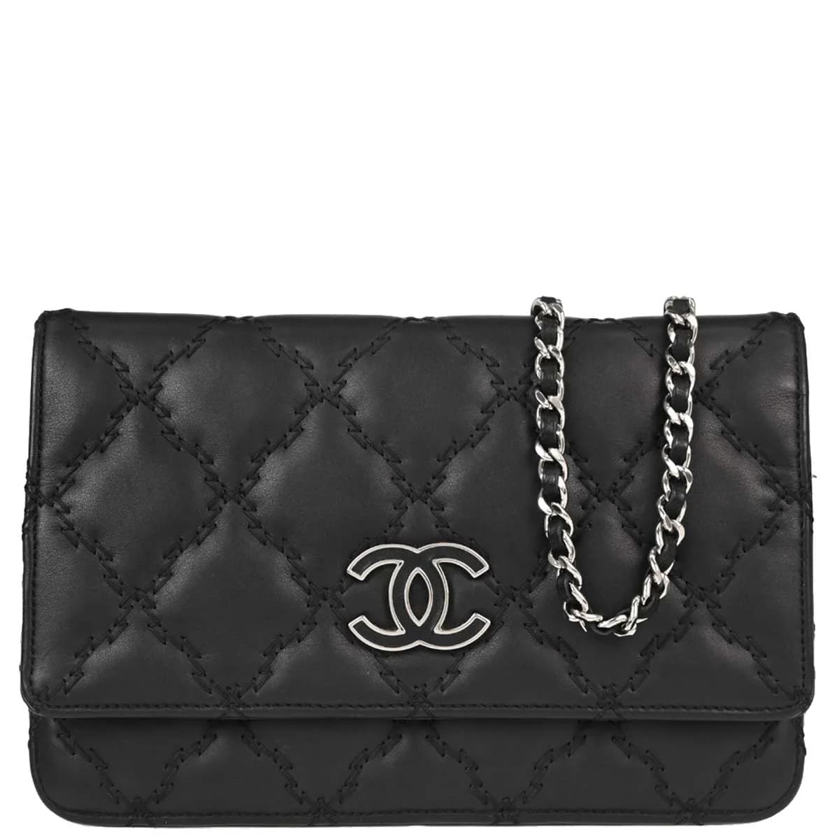 Small black leather flap bag on a chain strap, quilted front with turnlock closure.