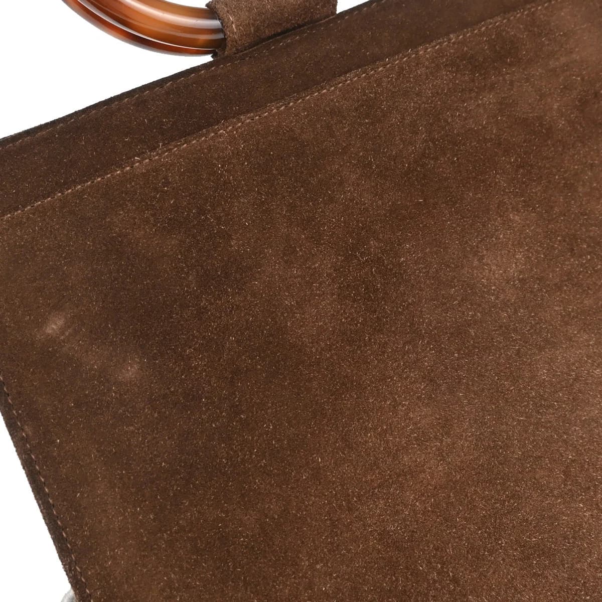 Brown suede handbag with mottled amber tortoiseshell-look handles and hardware