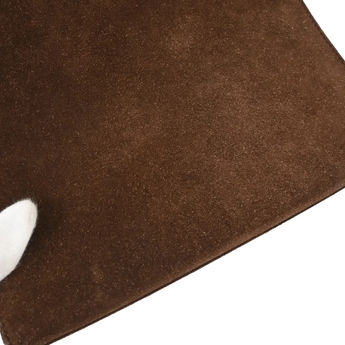 Brown suede handbag with mottled amber tortoiseshell-look handles and hardware