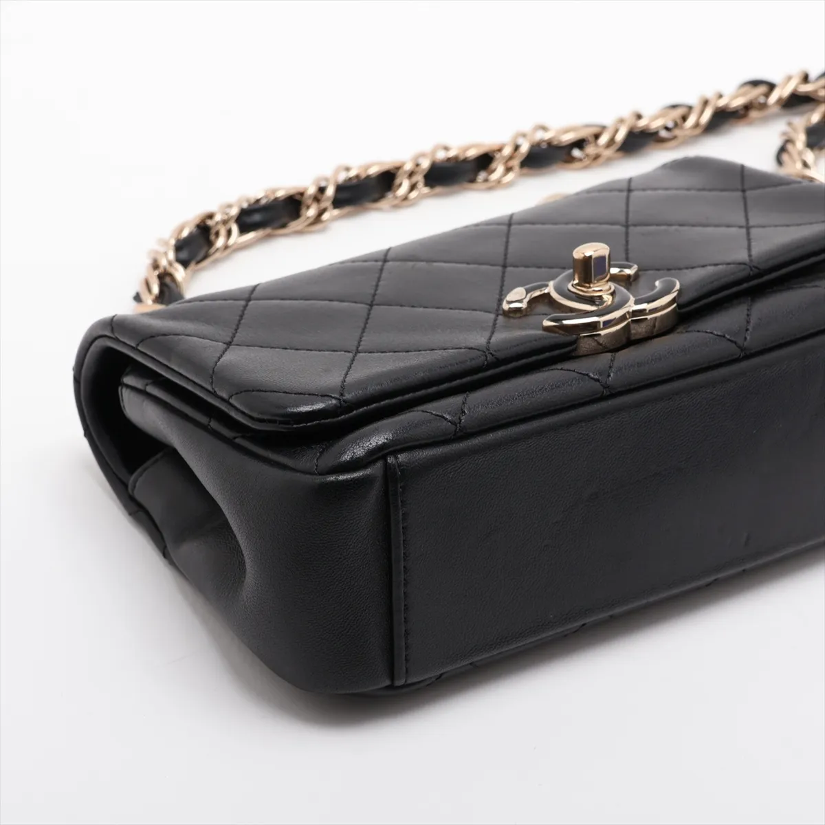 Quilted black leather flap bag with a gold-tone chain strap and turnlock closure