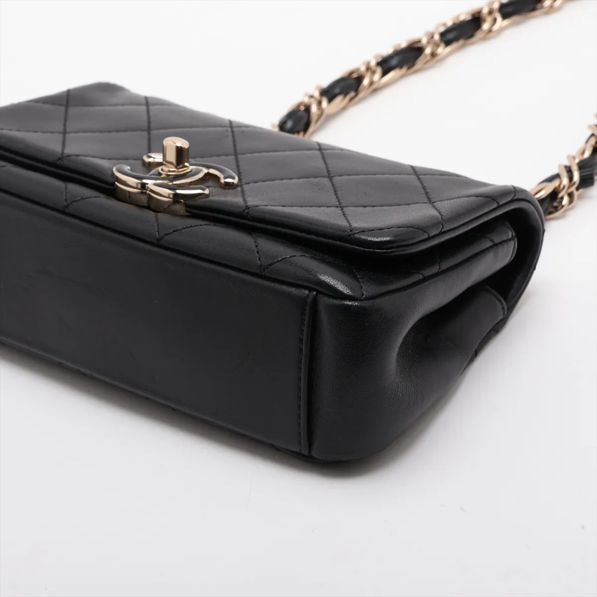 Quilted black leather flap bag with a gold-tone chain strap and turnlock closure