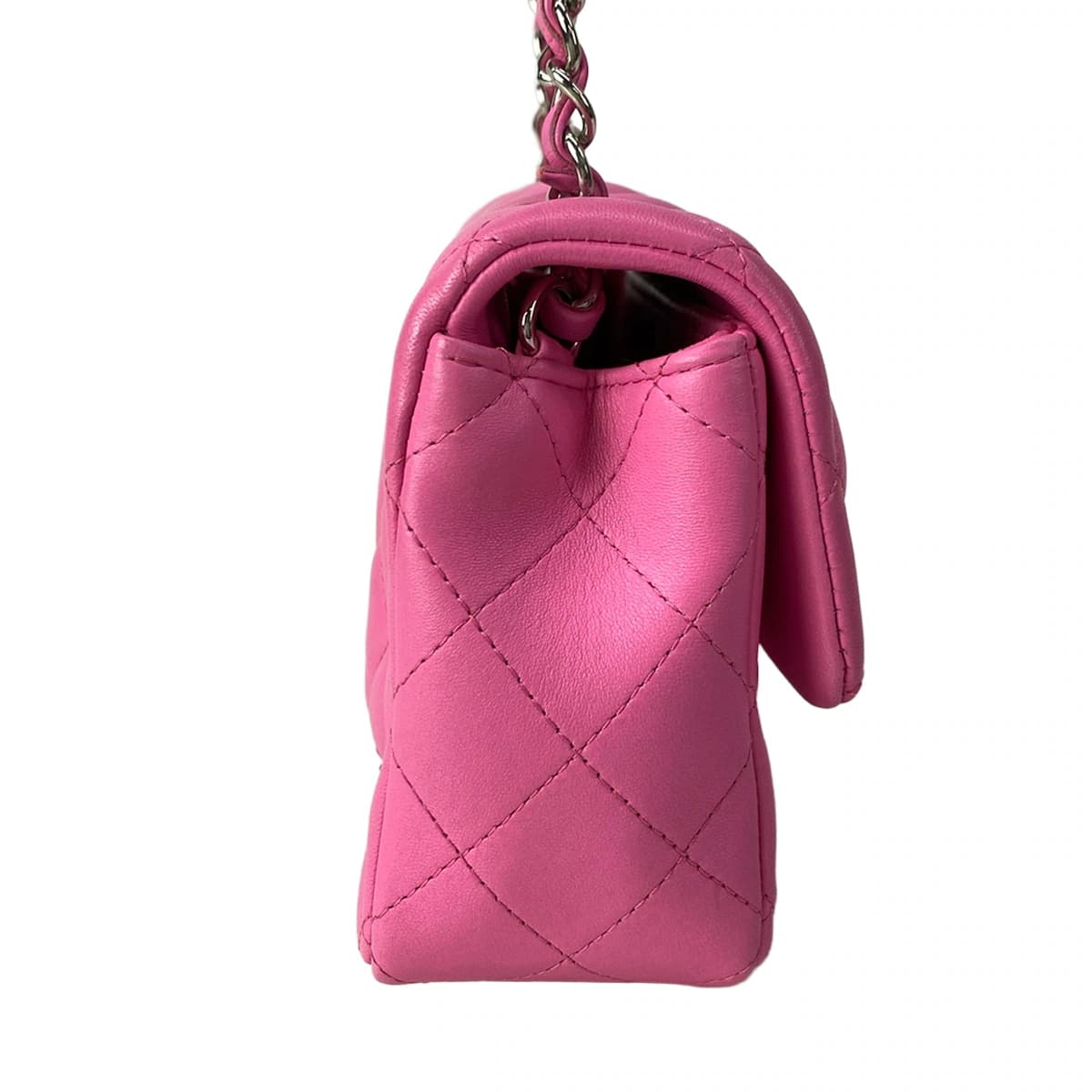 Small pink quilted bag with a chain shoulder strap.