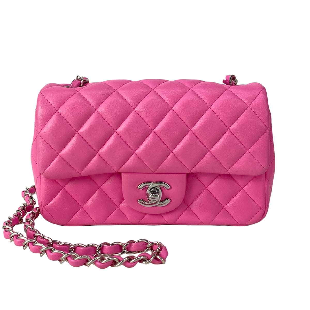 Small pink quilted bag with a chain shoulder strap.