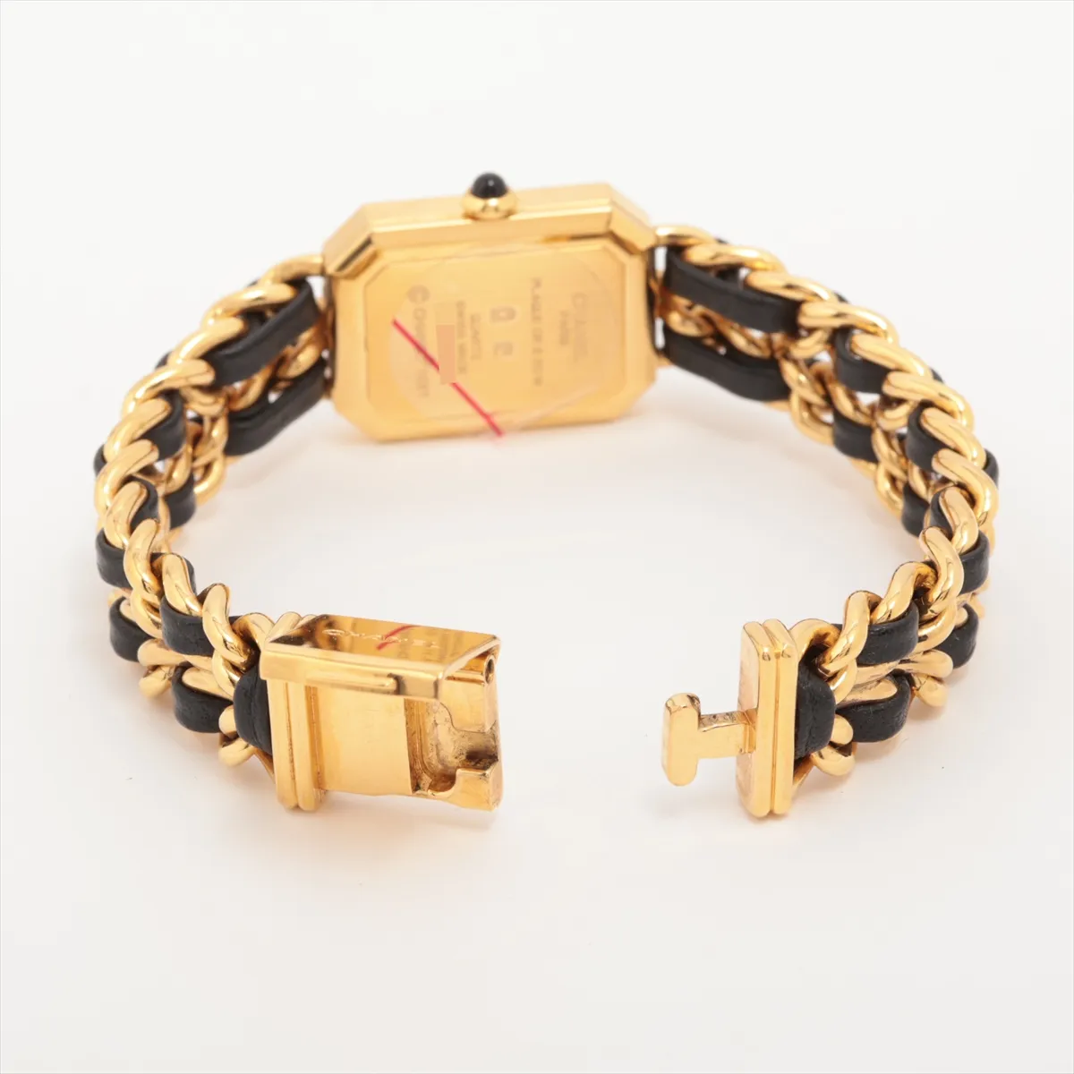 Gold-toned octagonal watch with black dial on a dark leather strap.