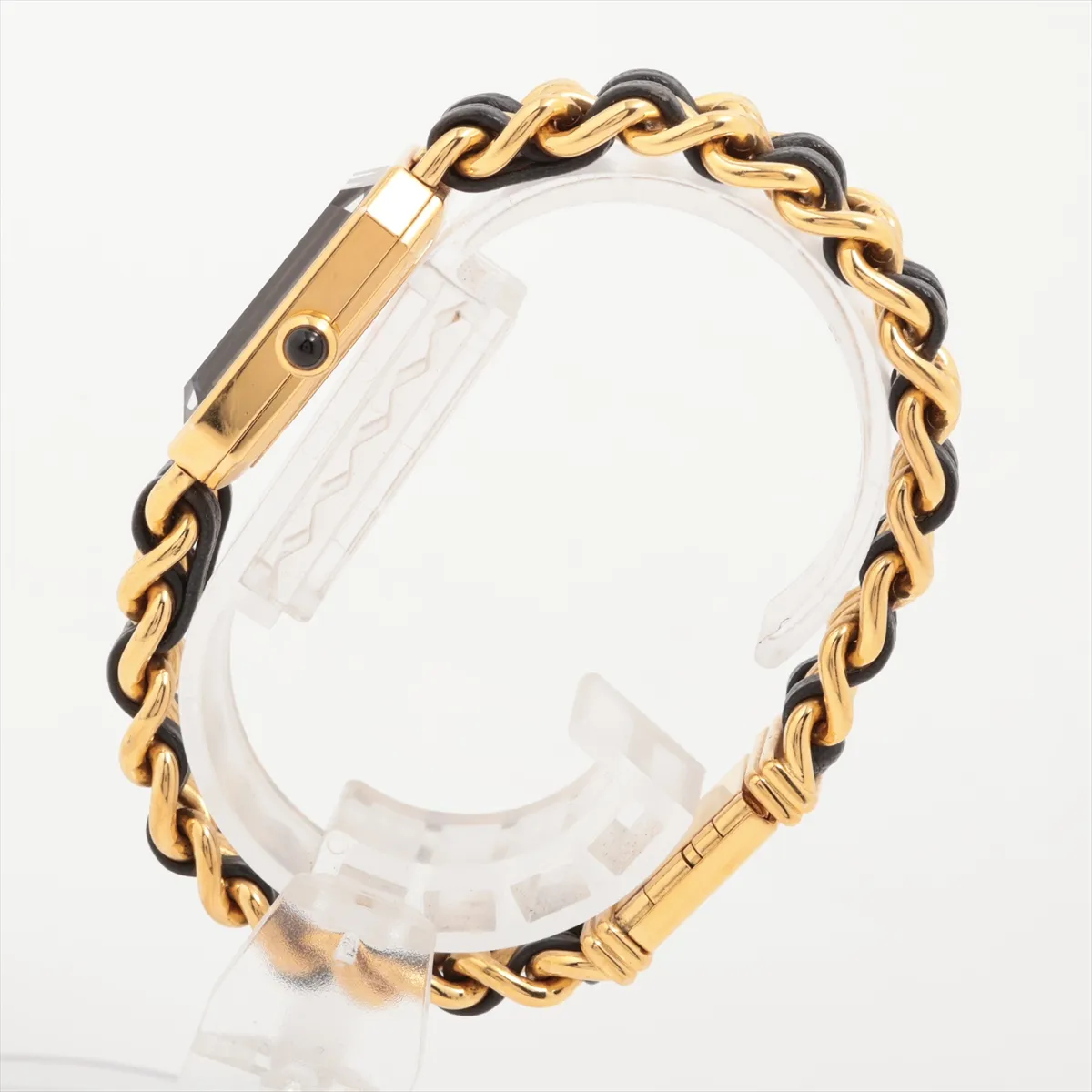Gold-toned octagonal watch with black dial on a dark leather strap.