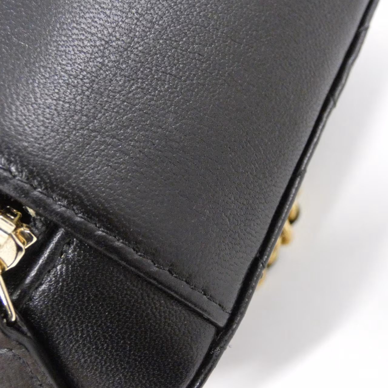 Shoulder bag with a chain strap photographed against a plain background.